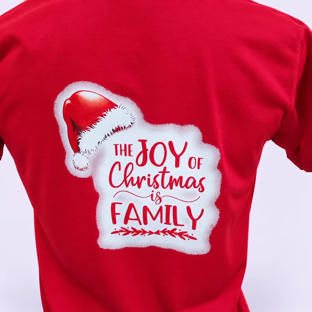 Red family Christmas shirt — print detail, pale-lilac studio treatment