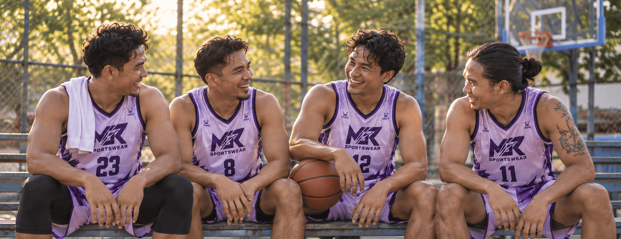 Basketball teammates in coordinated lilac MGR jerseys sharing a moment on the court.